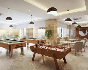 Spacious indoor clubhouse with pool tables, foosball, table tennis, and stylish lounge seating for recreation.